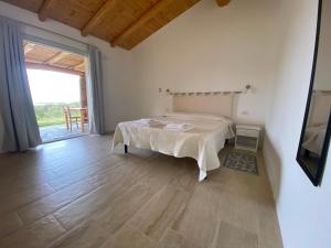 a bedroom with a bed and a large window at Il Vistamare in Rudalza