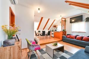 a living room with a couch and a table at Greta Rest House in Sopot