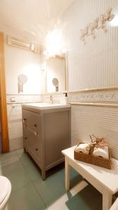 a bathroom with a sink and a mirror and a table at CASITA LUAN in Tragacete