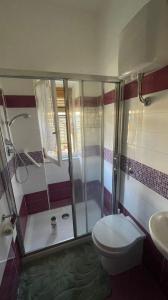 a bathroom with a shower and a toilet and a sink at Sea Life House in Alghero