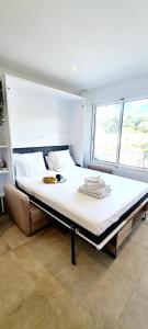 a large bed in a room with two windows at Studio Cannes in Cannes