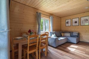 a living room with a table and a couch at Roztoczańska Ostoja in AdamÃ³w