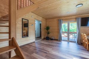 a room with wooden walls and wooden floors and a staircase at Roztoczańska Ostoja in AdamÃ³w +32 photos