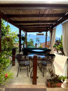 a patio with a ping pong table and chairs at Pousada Bela Vista in Abraão