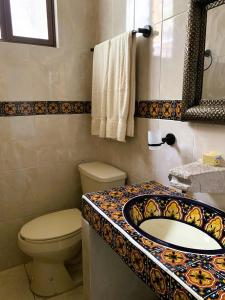 a bathroom with a toilet and a sink at La Capelina Apartment in ExHacienda la Escalera in Guanajuato +30 photos