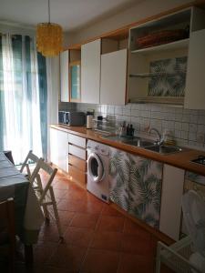 a kitchen with a washing machine and a sink at Casa Le Felci in Florence