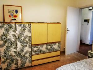 a yellow cabinet in a room with a bedroom at Casa Le Felci in Florence