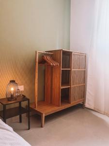 a wooden book shelf sitting next to a bed at Exclusive Paceville NEW 3 bedrooms apartment in St. Julianʼs