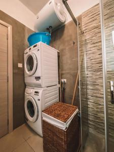 a washing machine and a dryer in a bathroom at Exclusive Paceville NEW 3 bedrooms apartment in St. Julianʼs
