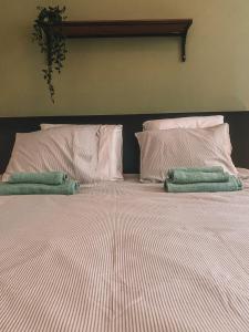 a bed with two pillows and two towels on it at Exclusive Paceville NEW 3 bedrooms apartment in St. Julianʼs