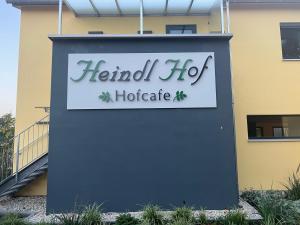 a sign for a herbal hog hotelitute in front of a building at HeindlHof in Ingolstadt