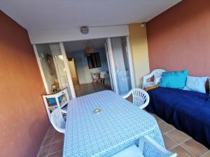 een kleine kamer met een tafel en een bed bij Superbe appartement Cap d'Agde in Cap d'Agde