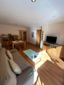 a living room with a couch and a table at Els Verns in Ribes de Freser