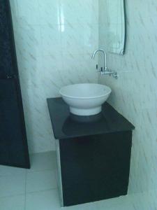 a bathroom with a sink and a mirror at Heaven Goa Guesthouse in Benaulim +8 photos