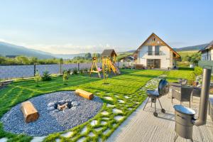 a backyard with a playground with a fire pit at Chalet West - Zuberec in Zuberec
