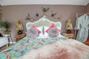 a bedroom with a large bed with pillows on it at The Loveshack Lodge Balquhidder in Balquhidder