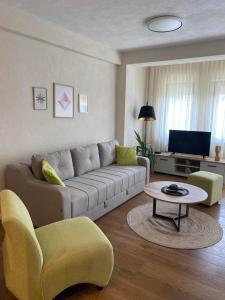 a living room with a couch and a table at Apartment N & N in Struga