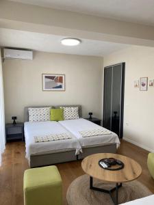 a bedroom with a bed and a coffee table at Apartment N & N in Struga