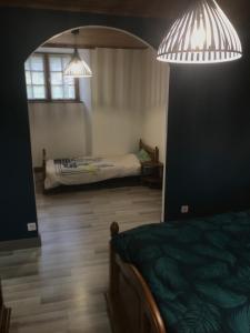 a bedroom with a bed and two lights above it at La Résidence de Marie in Brommat +2 photos
