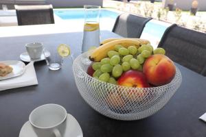 a bowl of fruit sitting on top of a table at Luxury Villa Meerbrise - Private Pool - Near Medulin, Kamenjak, Pola in Banjole