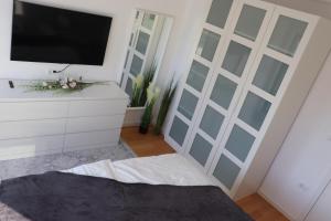 a bedroom with a sliding door with a tv at Luxury Villa Meerbrise - Private Pool - Near Medulin, Kamenjak, Pola in Banjole