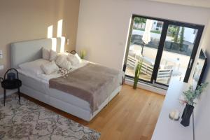 a bedroom with a white bed and a balcony at Luxury Villa Meerbrise - Private Pool - Near Medulin, Kamenjak, Pola in Banjole +35 photos
