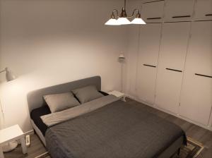 Dormitorio pequeño con cama y armarios blancos en Ihan Puotilan Metron lähellä, en Helsinki