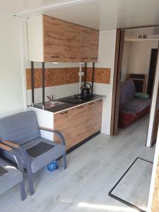 a kitchen with a couch and a chair in a room at Pływający Dom in Zegrze