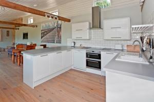 a kitchen with white cabinets and a counter top at Valley Barn Slad Valley Cotswolds in Painswick