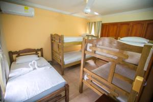 a small room with two bunk beds and a room with another bed at Hostal Cartagonova - Habitaciones privadas y amplias cerca a zonas turísticas in Cartagena de Indias