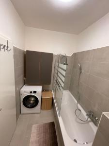 a bathroom with a washing machine and a washer at Ruhige Ferienwohnung in Rostock