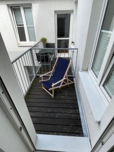 a balcony with a blue chair and a table at Ruhige Ferienwohnung in Rostock