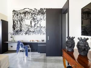 a living room with a painting on the wall at Donna Carmela Resort & Lodges in Riposto