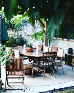 a wooden table and chairs on a patio at MAGNOLIA HOME 32 in Auch