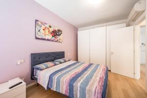 a bedroom with a bed and a painting on the wall at La Casa di Edo - WiFi Parking free in Modena
