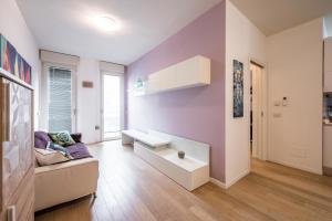 a living room with purple walls and a couch at La Casa di Edo - WiFi Parking free in Modena