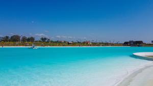 a large body of blue water with a beach at Sun Cottage - Mar Adentro in Santa Cruz de la Sierra