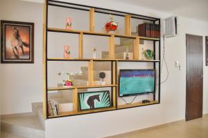 a room with a shelf with a tv in it at Sun Cottage - Mar Adentro in Santa Cruz de la Sierra