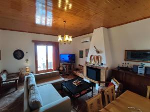 uma sala de estar com um sofá e uma mesa em THOMAS VIEW Εξοχικό σπίτι με θέα στη θάλασσα em Porto Heli