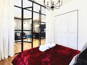 a bedroom with a red bed and a living room at F L O R E N T I N Design Apartment ChicLife in Bergamo