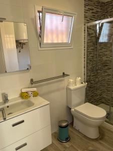 a bathroom with a toilet and a sink and a shower at LOS ANGELES APARTMENT Los Cristianos in Los Cristianos +19 photos