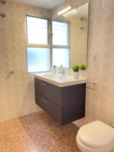 a bathroom with a sink and a toilet and a window at UIM Mediterraneo Isabel 23 Wifi in Puerto de Sagunto +8 photos