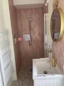 a bathroom with a white sink and a mirror at Toms Cottage in Longford