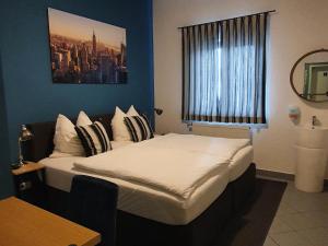 a bedroom with a large bed with a window at ARGENTA Living 131 in Künzell