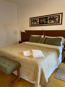 a bedroom with a large bed with two towels on it at Hostal Andino - Adults Only in Cafayate +21 photos