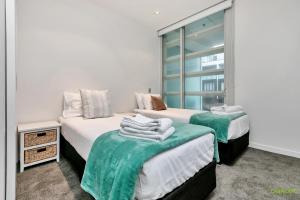 Ein Bett oder Betten in einem Zimmer der Unterkunft QV Waterfront Apartment Viaduct Area - 503