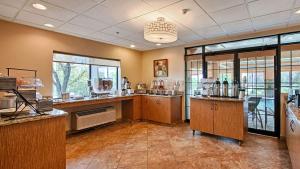 a large room with a counter with glasses on it at Comfort Inn & Suites Copley Akron in Copley