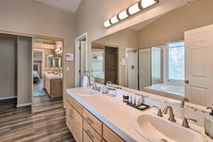a bathroom with two sinks and a large mirror at A Beautiful House with Hot Tub, Grill & Games! in Las Vegas +30 photos