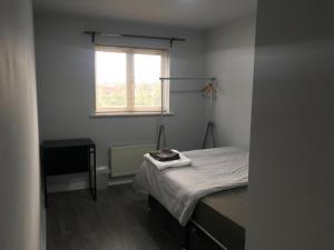 a small bedroom with a bed and a window at Comfortable Stay 