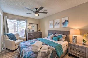 a bedroom with a bed with a ceiling fan and a chair at A Beautiful House with Hot Tub, Grill & Games! in Las Vegas
